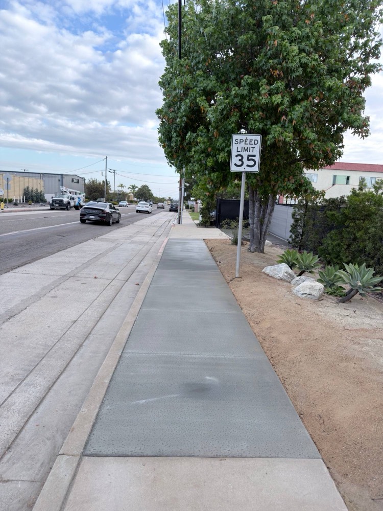 The same frontage after replacement — new concrete sidewalk to City of San Diego spec